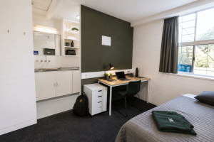 Mannix Bedroom Sample (8) Refurbished student bedroom with additional wardrobe space, featuring a king single bed, study desk, expanded built-in wardrobe, sink, heater and high-speed Wi-Fi.
